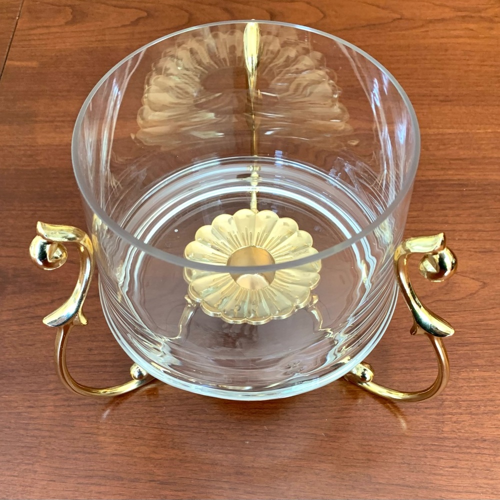 Clear glass serving dish and glod tone metal frame warmer